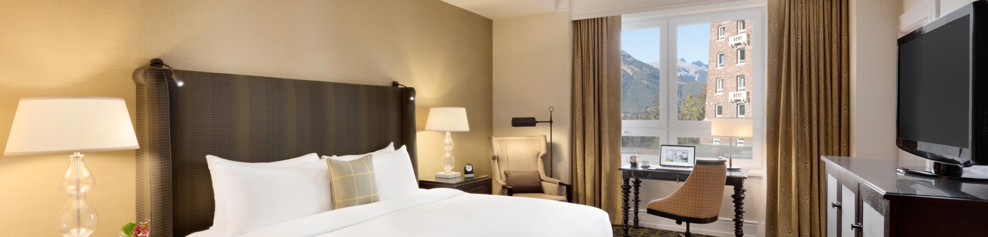 Bedroom with small desk and view of the mountains