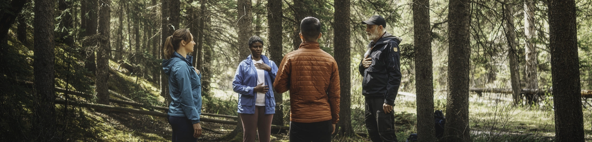 a group of people standing in a forest