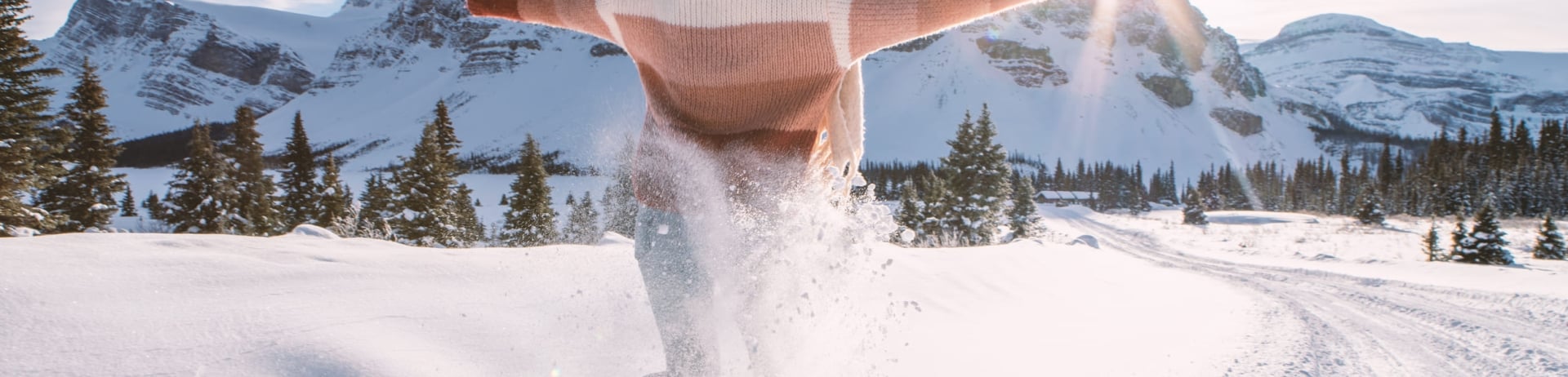 woman running through the snow in snowshoes