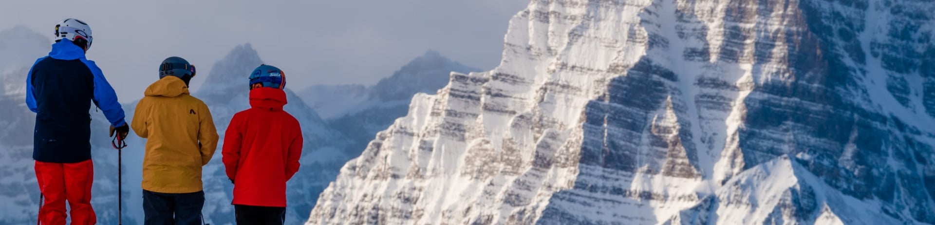 family looking over the mountains while skiing