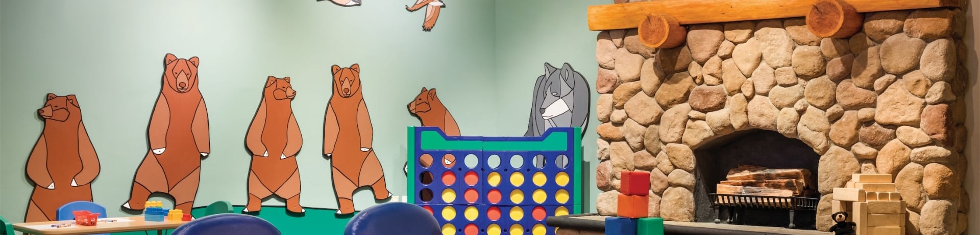 kids play room with a fireplace and decorated with bright colours