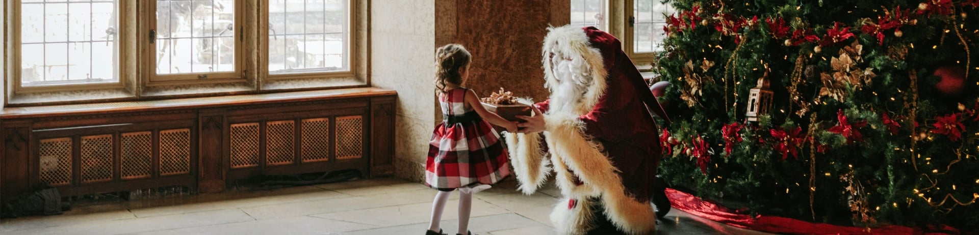 santa giving a little girl a gift