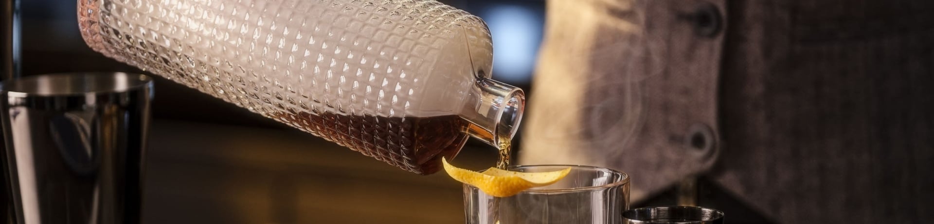 bartender pouring a cocktail