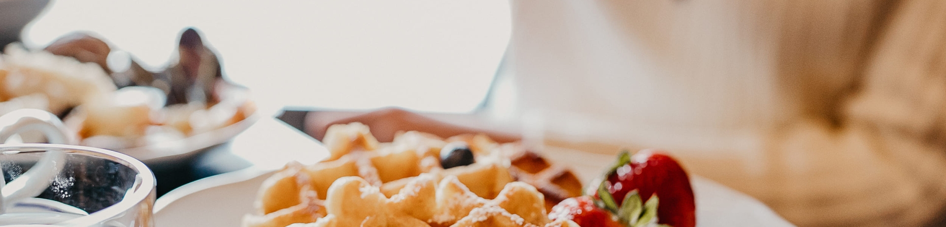 close up of a plate of waffles and strawberries