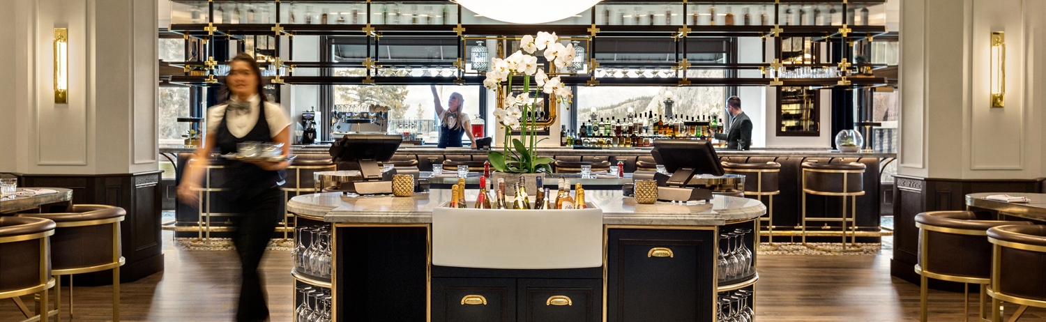 view of servers behind bar and walking through restaurant area