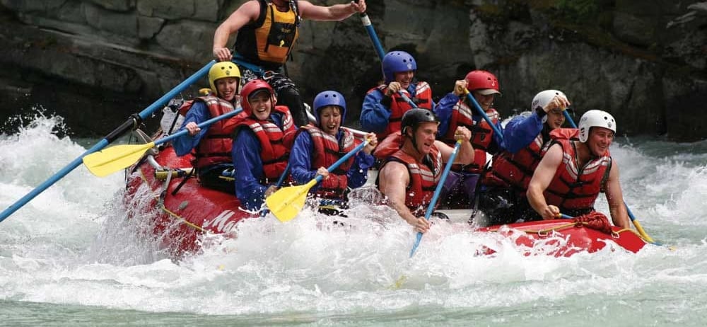 a group of people white water rafting