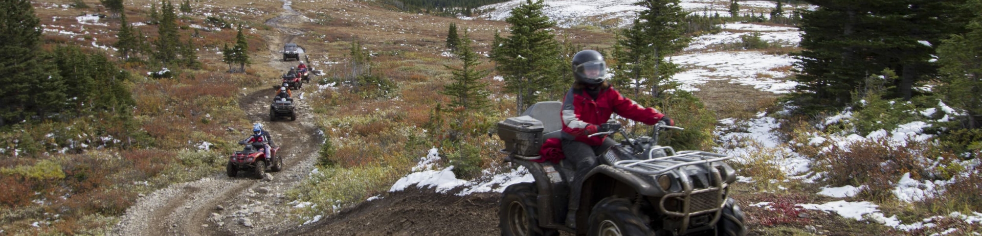 people riding atvs on dirt trails