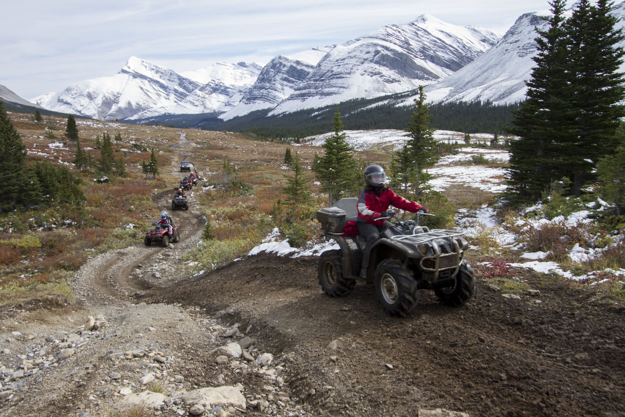 people riding atvs on dirt trails