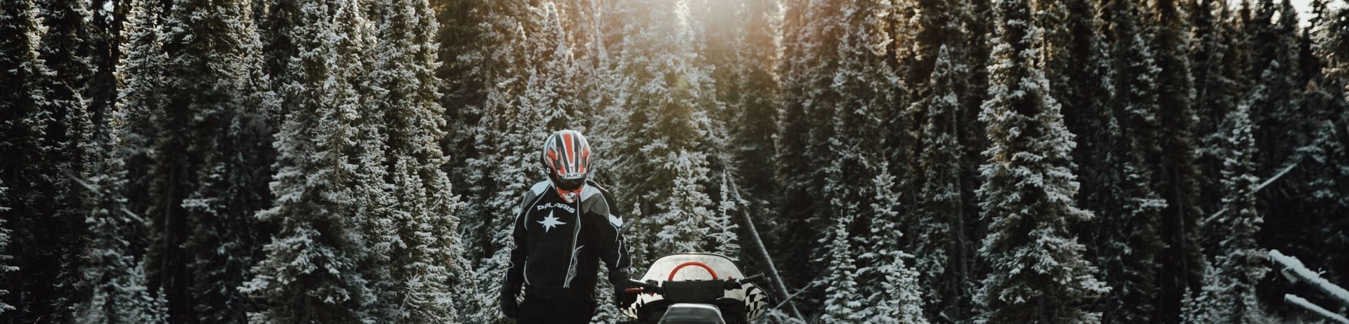 a man parking a snowmobile