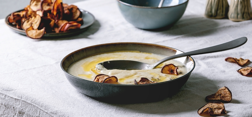 soup in ceramic bowl on table with white tablecloth