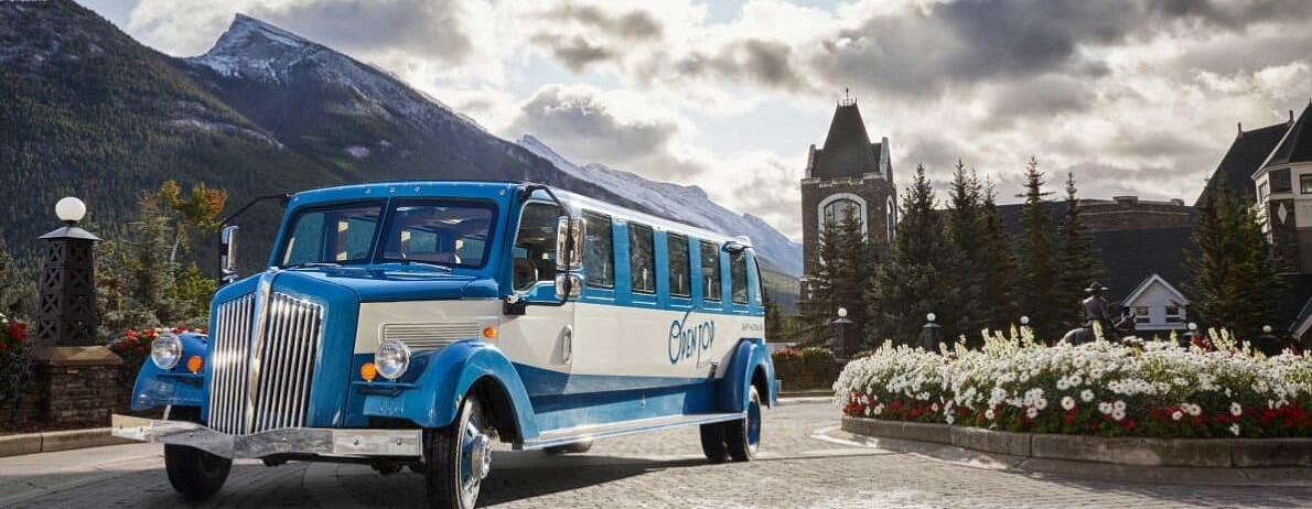 an old time tour bus parked in front of the resort