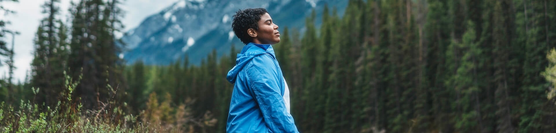 woman sitting on her knees next to the river