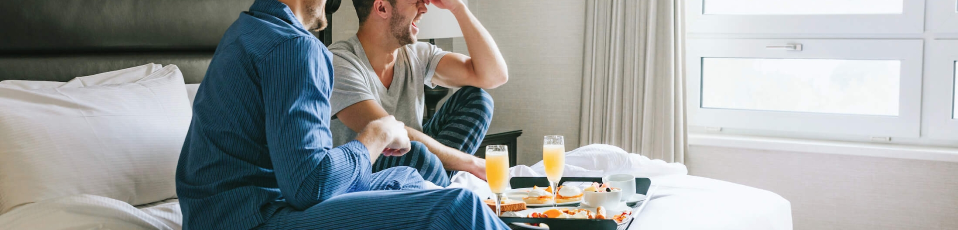 a couple eating breakfast in bed