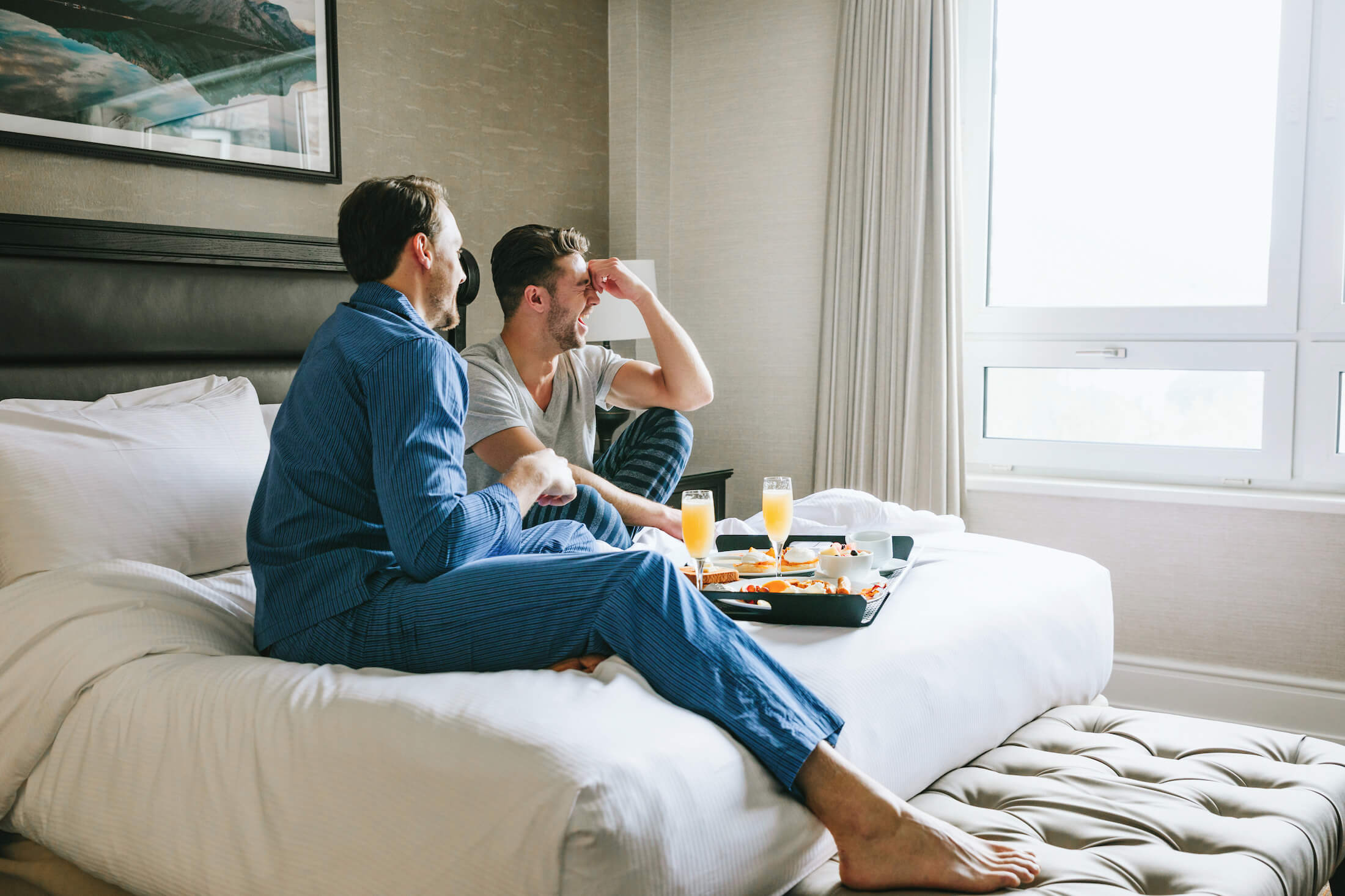 a couple eating breakfast in bed