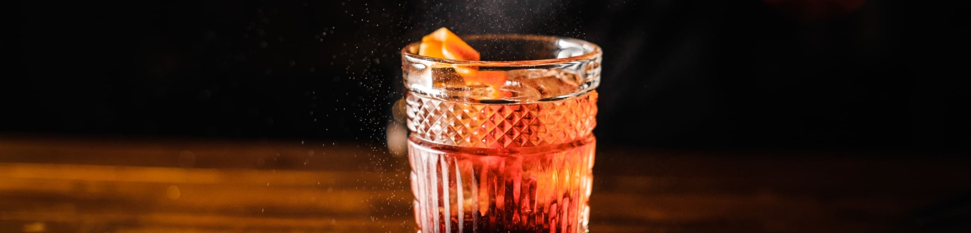 bartender adding garnish to a drink