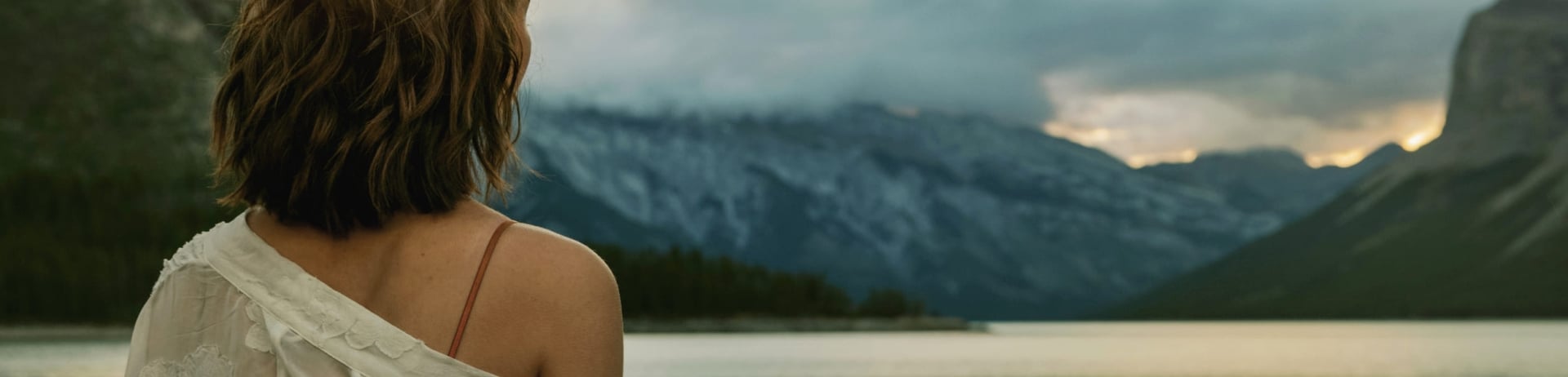 woman staring out at a lake