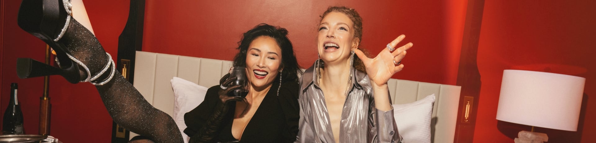 two women enjoying in-room dining in bed in the Terrace Suite.