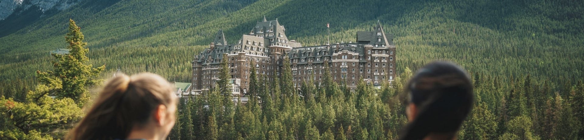 Two people looking out at Fairmont Banff Springs